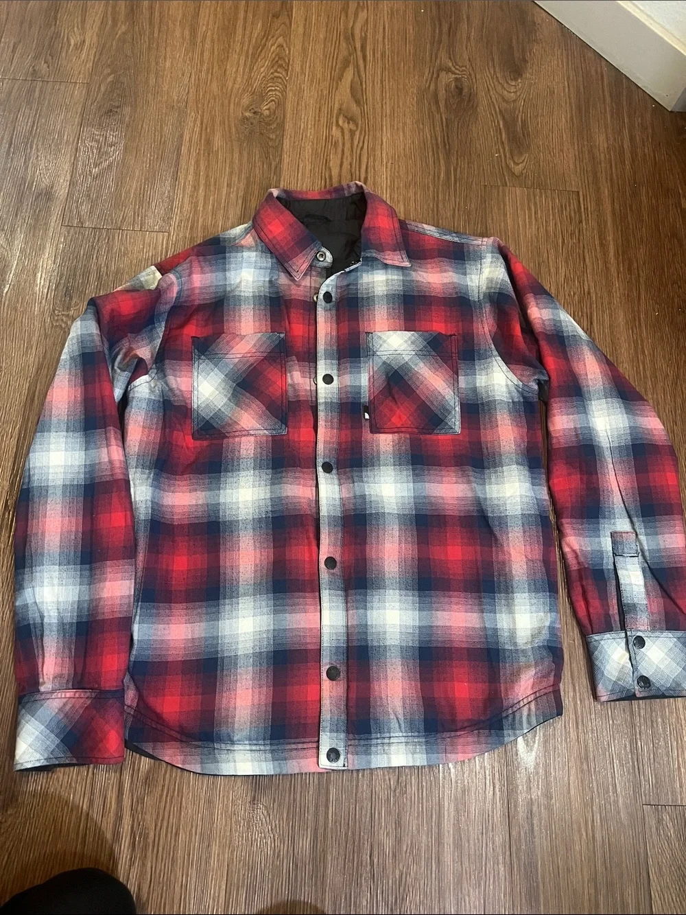 The North Face Black Jacket with Red & Blue Plaid Lining can be worn inside-out